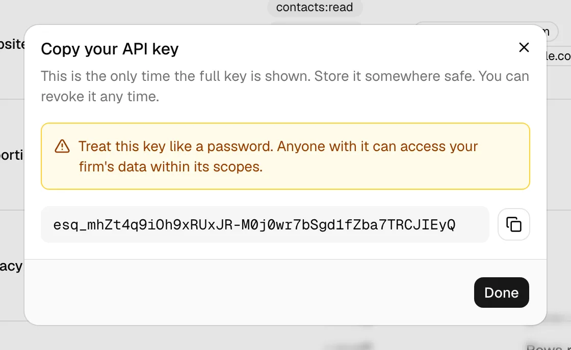 The "Copy your API key" view showing the full esq_… key in a code box with a copy button and the amber warning that this is the only time the full key is