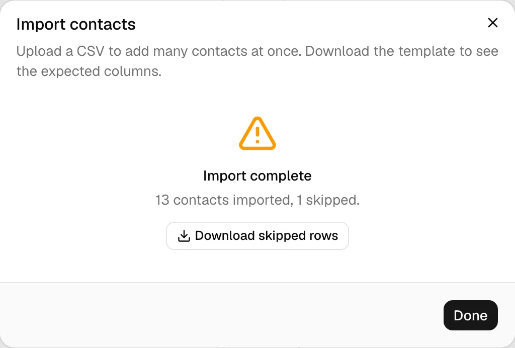 The completion summary showing the amber warning, "N contacts imported, M skipped", and the Download skipped rows button, alongside the downloaded report open