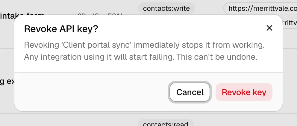 The Revoke confirmation dialog warning that revoking the key immediately stops it from working and cannot be undone.
